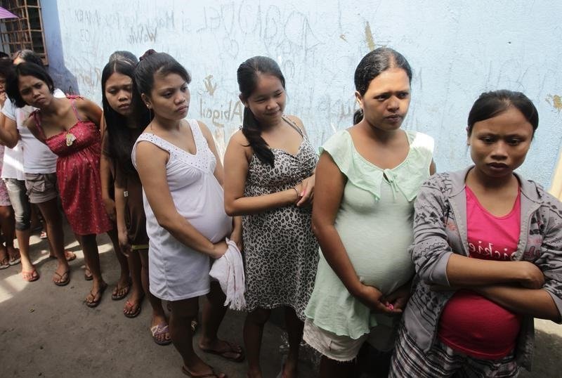 Pregnant teenagers queue for a free pre-natal check-up during a medical mission for teenage pregnancy conducted by the aid agency UNFPA (United Nations Populations Fund) in the slum community of Vitas in Tondo, Manila